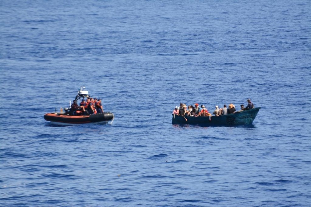 A small boat crew from the Coast Guard Cutter Dauntless approaches a rustic vessel with Cuban migrants onboard south of Marathon, Fla., on June 13, 2016.