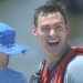 Coast Guard Rescue swimmer Stephen Scheren laughs with his son