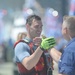 Coast Guard rescue swimmer congratulated by Chief Warrant Officer Gall