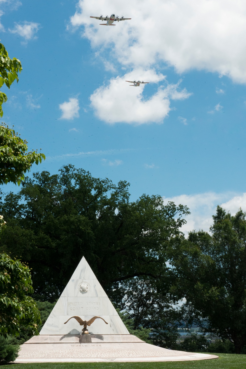 U.S. Coast Guard flies over Arlington National Cemetery to mark the 100th anniversary of Coast Guard aviation