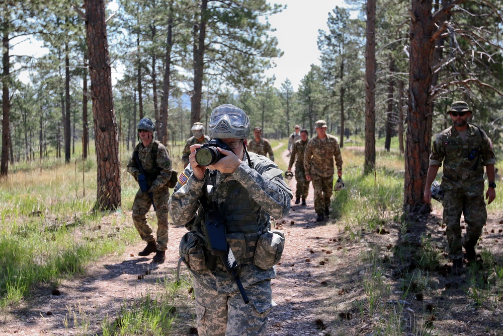 Soldier shoots photo during urban patrol