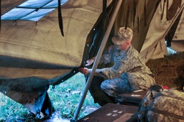 Soldier attempts to secure tent during severe weather