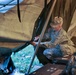 Soldier attempts to secure tent during severe weather