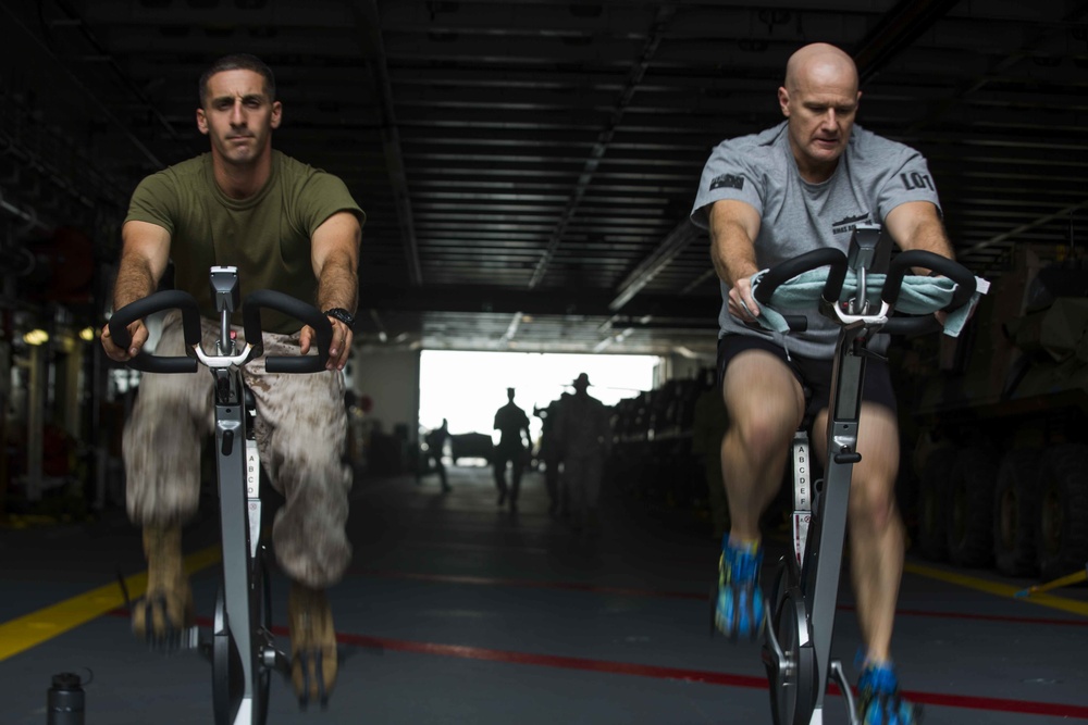 U.S. and Australian forces compete in cycling challenge aboard HMAS Adelaide