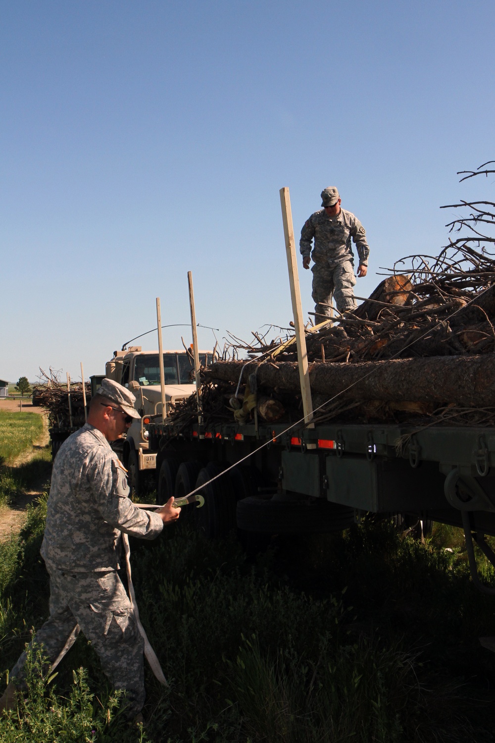 Soldiers supply timber to local tribal communities