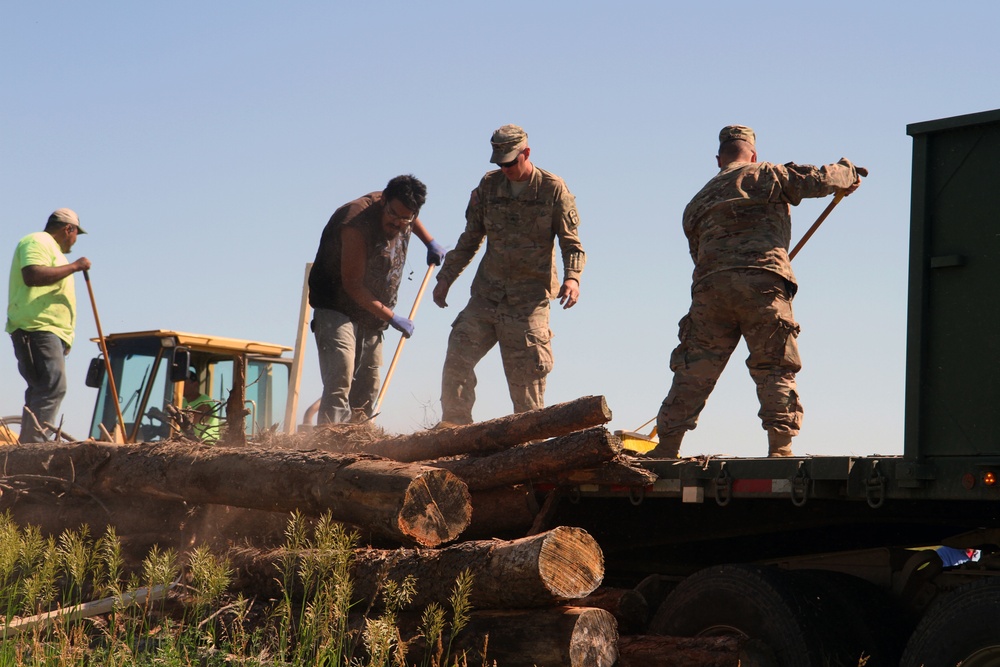 Soldiers supply timber to local tribal communities