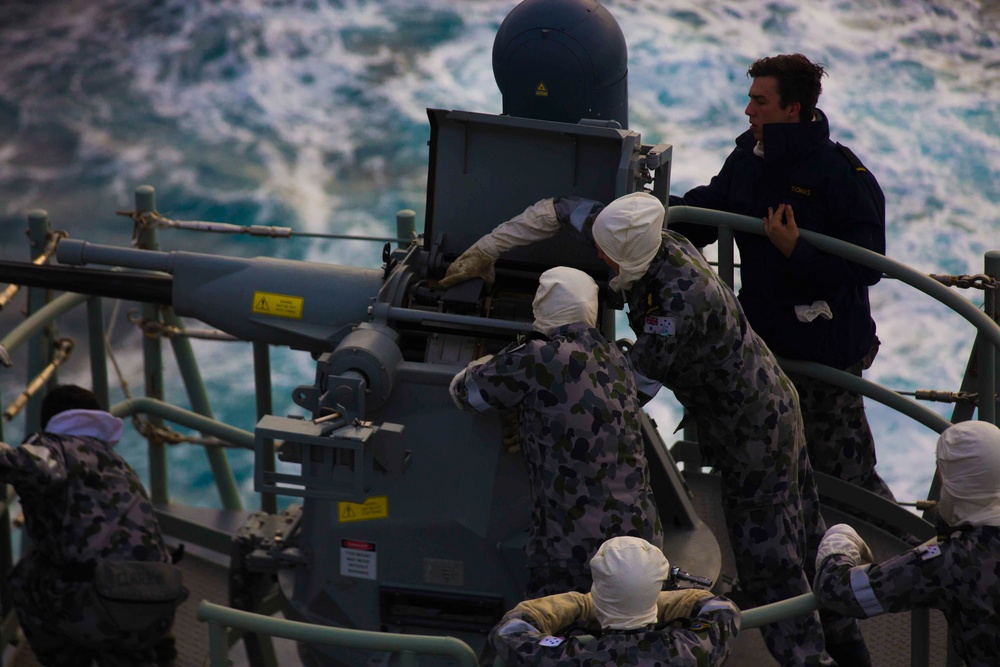 Australian sailors fire 25 millimeter Typhoon off HMAS Adelaide