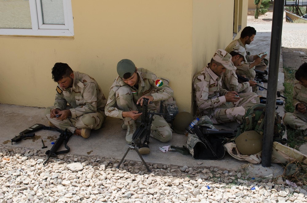 Peshmerga soldiers conduct weapons maintenance