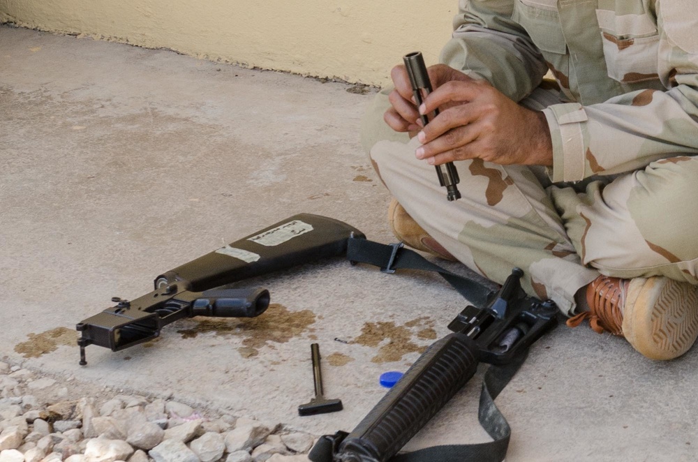 Peshmerga soldiers conduct weapons maintenance