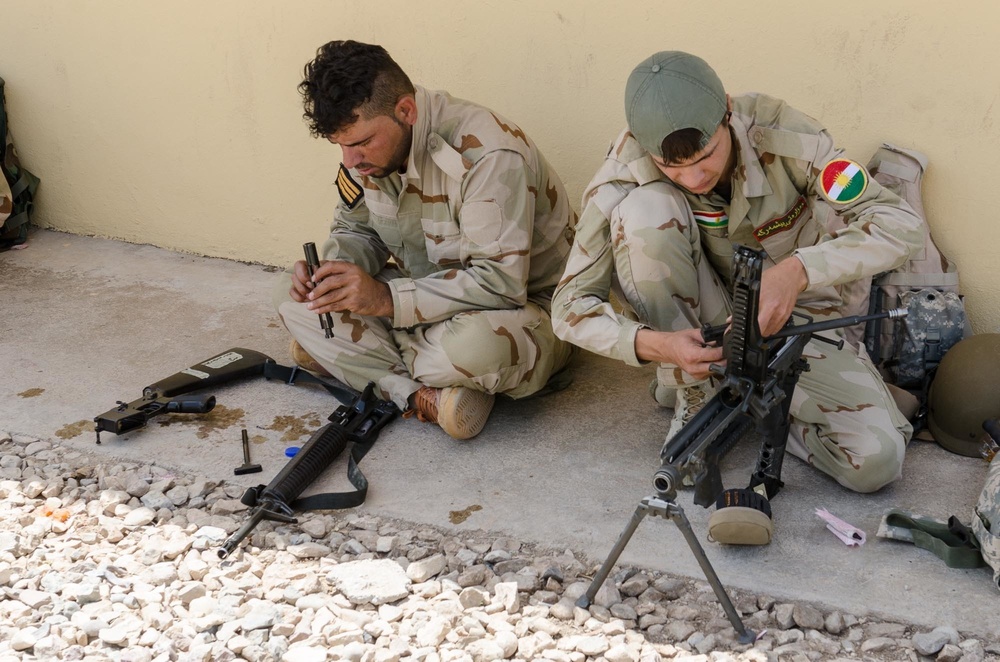 Peshmerga soldiers conduct weapons maintenance