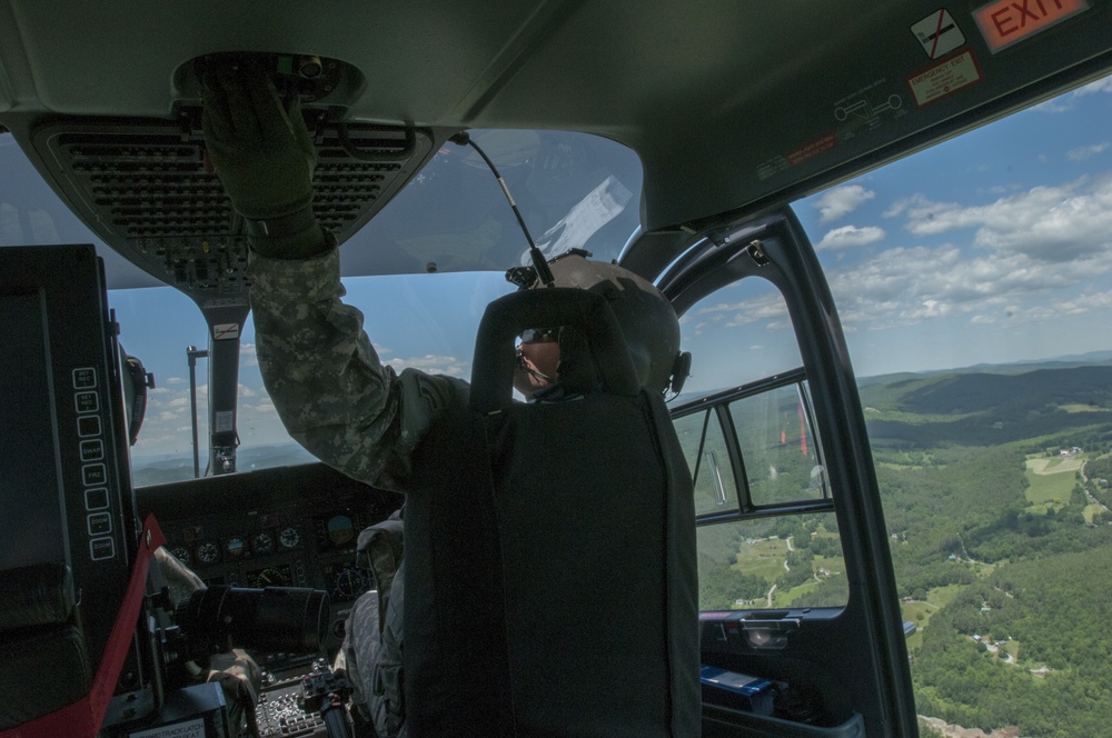UH-72 Lakota Helicopter Pilot Reaches for a Switch