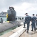 Members of Commander, Submarine Squadron 15 welcome USS Topeka home