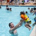 Army Chief Warrant Officer 2 Bryan Crumpler catches his daughter, Quinn, age 2, as she leaps from the edge of the pool during the Marine Corps Community Services All American BBQ at the Oasis Pool and Water Park aboard Marine Corps Logistics Base Barstow,