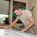 Soldier in Marketing Prepares Equipment Tracking Board