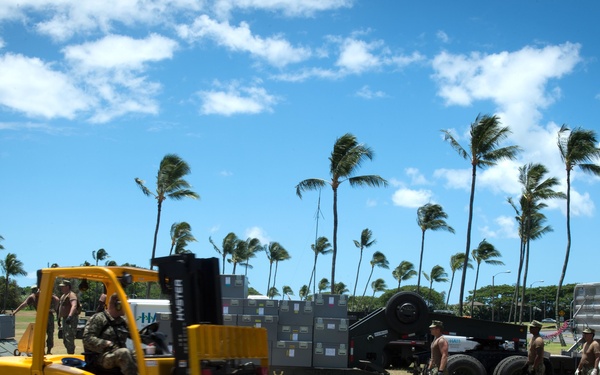 Sailors assigned Navy Cargo Handling Battalion (NCHB) 8 and NCHB 10 unload equipment and materials to setup a field hospital for RIMPAC