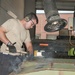 Metal Worker Hammers Out Bolts