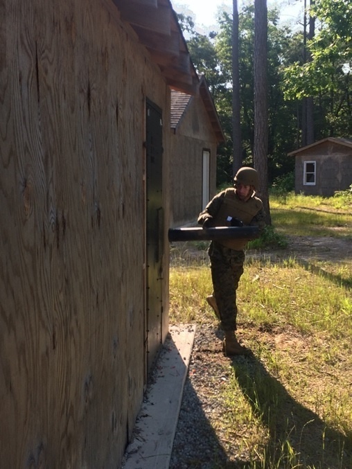 Marine Engineer student breaches a building door with a battering ram