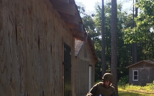 Marine Engineer student breaches a building door with a battering ram