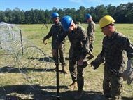 Marines attached to Combat Engineer Officer course 5-16 (CEO 5-16) emplace triple standard concertina wire