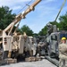 Secretary of the Army loads up a Humvee from a Mine-Resistant Ambush Protected wrecker