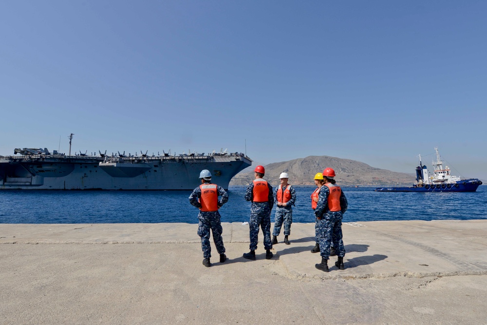 Sailors stand by as the aircraft carrier USS Harry S. Truman (CVN 75) arrives at Naval Support Activity Souda Bay, Greece