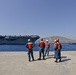 Sailors stand by as the aircraft carrier USS Harry S. Truman (CVN 75) arrives at Naval Support Activity Souda Bay, Greece