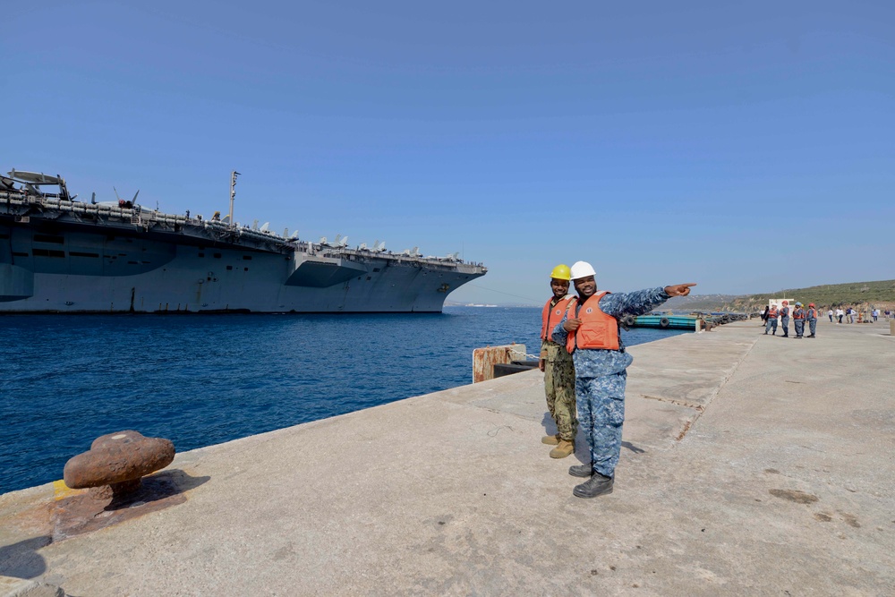 Sailors stand by as the aircraft carrier USS Harry S. Truman (CVN 75) arrives at Naval Support Activity Souda Bay, Greece