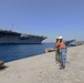 Sailors stand by as the aircraft carrier USS Harry S. Truman (CVN 75) arrives at Naval Support Activity Souda Bay, Greece