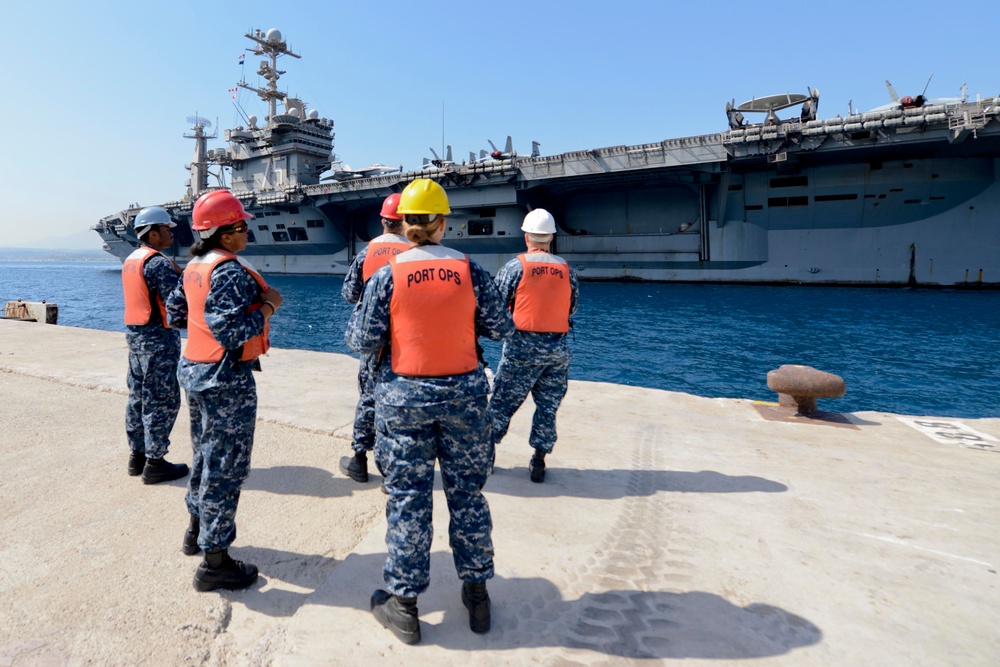 Sailors stand by as the aircraft carrier USS Harry S. Truman (CVN 75) arrives at Naval Support Activity Souda Bay