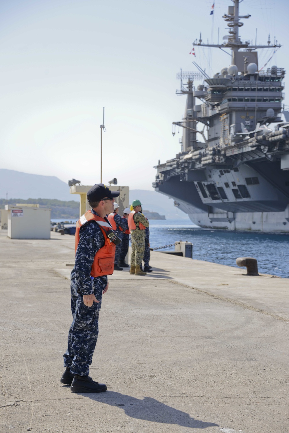 Sailors stand by as the aircraft carrier USS Harry S. Truman (CVN 75) arrives at Naval Support Activity Souda Bay