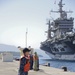 Sailors stand by as the aircraft carrier USS Harry S. Truman (CVN 75) arrives at Naval Support Activity Souda Bay