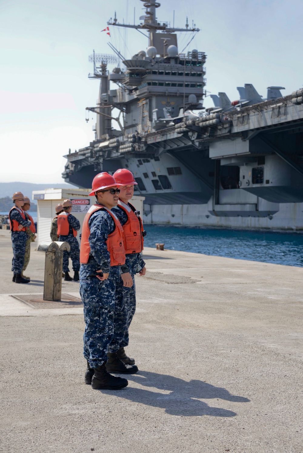 Sailors stand by as the aircraft carrier USS Harry S. Truman (CVN 75) arrives at Naval Support Activity Souda Bay