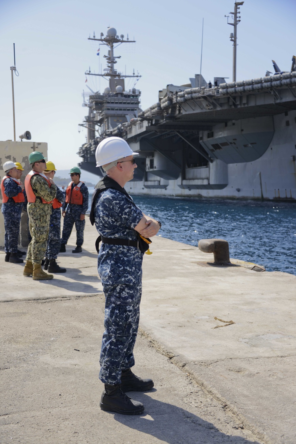 Sailors stand by as the aircraft carrier USS Harry S. Truman (CVN 75) arrives at Naval Support Activity Souda Bay