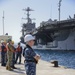 Sailors stand by as the aircraft carrier USS Harry S. Truman (CVN 75) arrives at Naval Support Activity Souda Bay