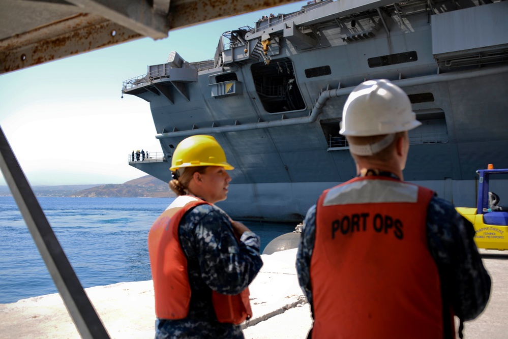 Sailors stand by as the aircraft carrier USS Harry S. Truman (CVN 75) arrives at Naval Support Activity Souda Bay