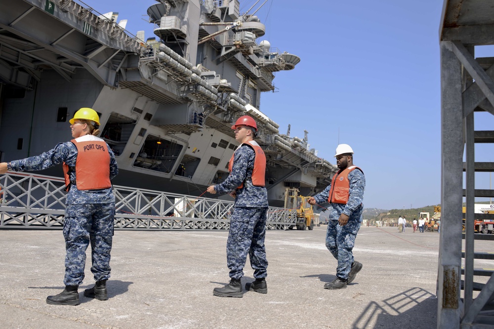 Sailors handle lines as the aircraft carrier USS Harry S. Truman (CVN 75) arrives at Naval Support Activity Souda Bay