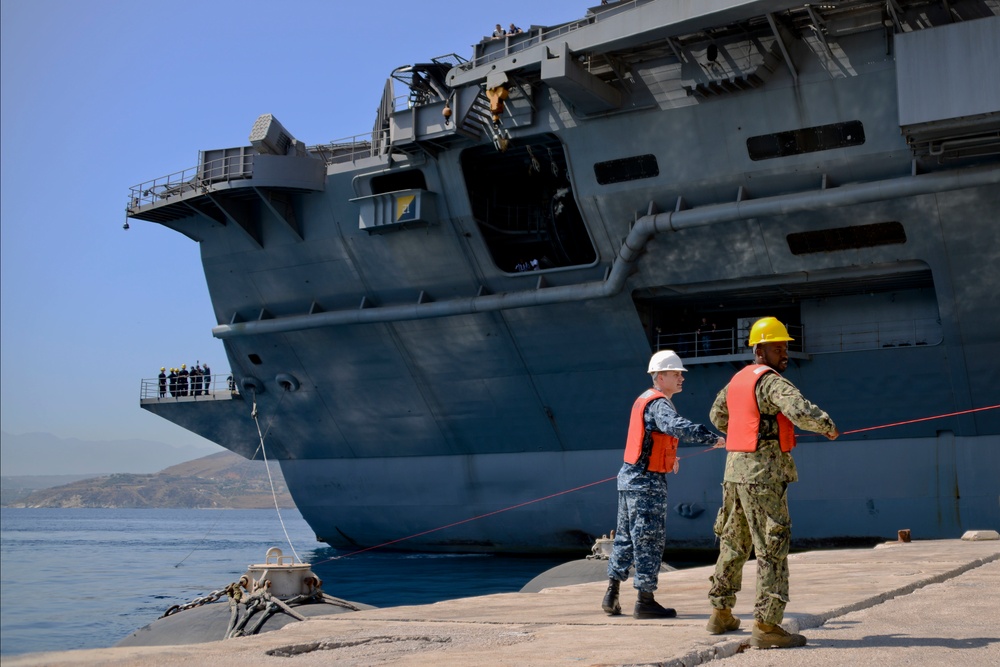 Sailors handle lines as the aircraft carrier USS Harry S. Truman (CVN 75) arrives at Naval Support Activity Souda Bay