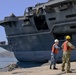 Sailors handle lines as the aircraft carrier USS Harry S. Truman (CVN 75) arrives at Naval Support Activity Souda Bay