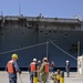 Sailors handle lines as the aircraft carrier USS Harry S. Truman (CVN 75) arrives at Naval Support Activity Souda Bay