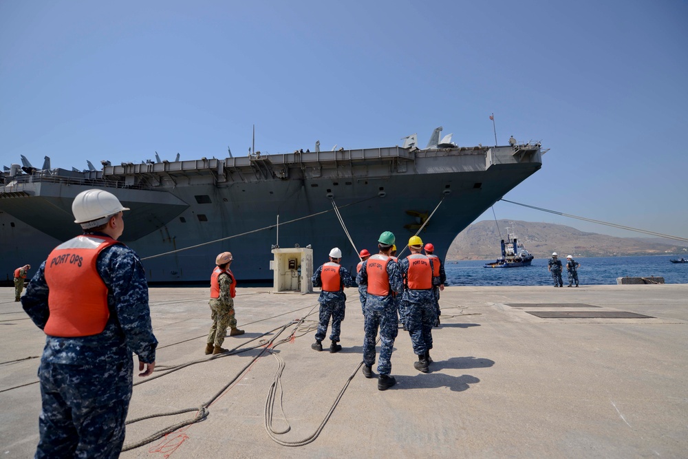 Sailors handle lines as the aircraft carrier USS Harry S. Truman (CVN 75) arrives at Naval Support Activity Souda Bay