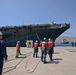 Sailors handle lines as the aircraft carrier USS Harry S. Truman (CVN 75) arrives at Naval Support Activity Souda Bay