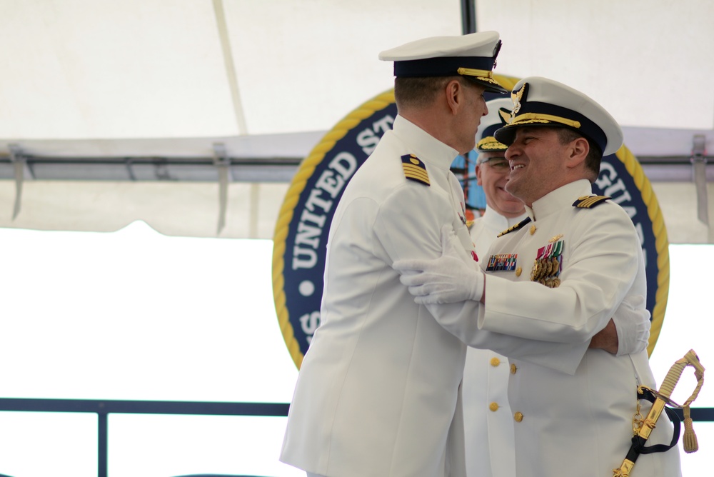 Capt. Anthony Ceraolo and Capt. Greg Stump hug during a change of command ceremony