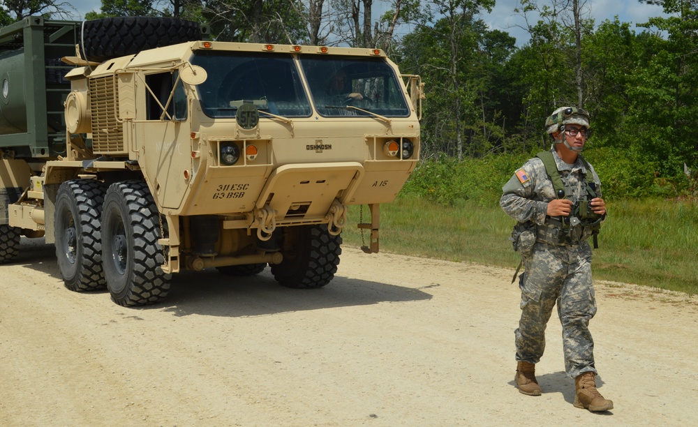 Soldier guides a HEMTT during Warrior Exercise (WAREX)