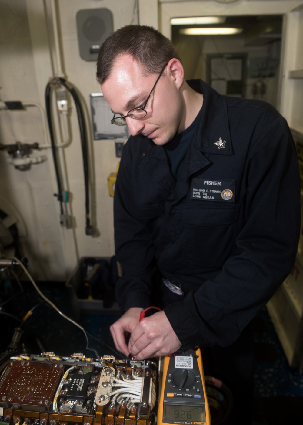 John C. Stennis Sailor checks aircraft generator during RIMPAC