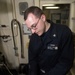 John C. Stennis Sailor checks aircraft generator during RIMPAC