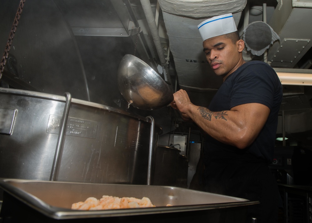 John C. Stennis Sailor prepares food during RIMPAC