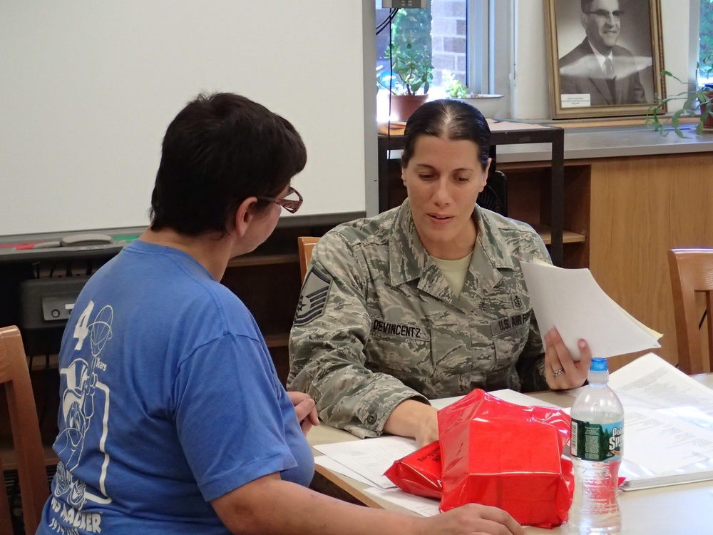 Airman provides medical information to community member in Norwich, N.Y.