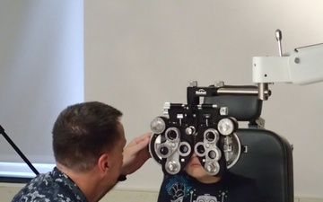 Service member provides eye care during the IRT Event in Norwich, N.Y.