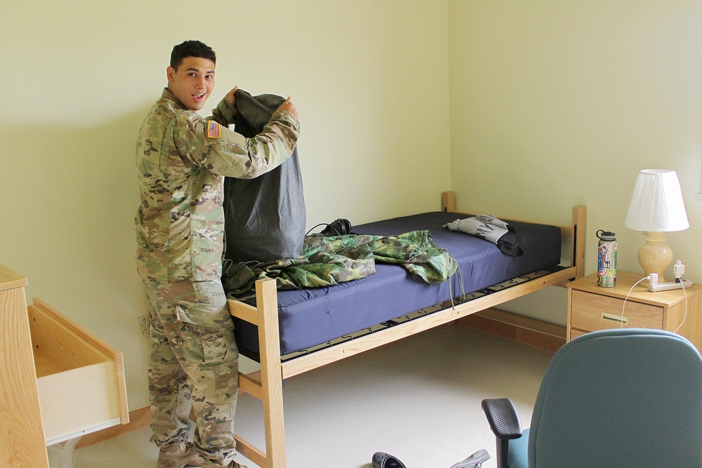 Unpacking in his new room