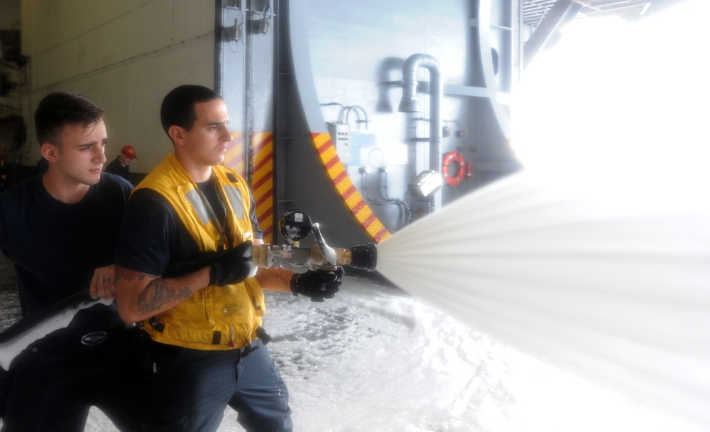 Air department Sailors conduct an aqueous film forming foam (AFFF) system test in the hangar bay of the aircraft carrier USS George H.W. Bush (CVN 77). GHWB is conducting sea trials to complete a planned incremental availability. After completion she will